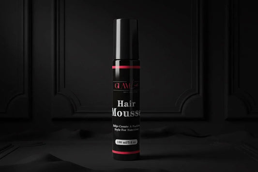 Glam Luxe Hair Collection hair mousse bottle with pump dispenser, white and gold packaging, on a neutral background.